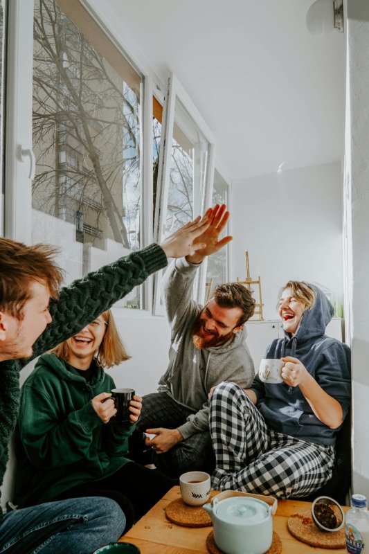 group of friends laughing and having coffee